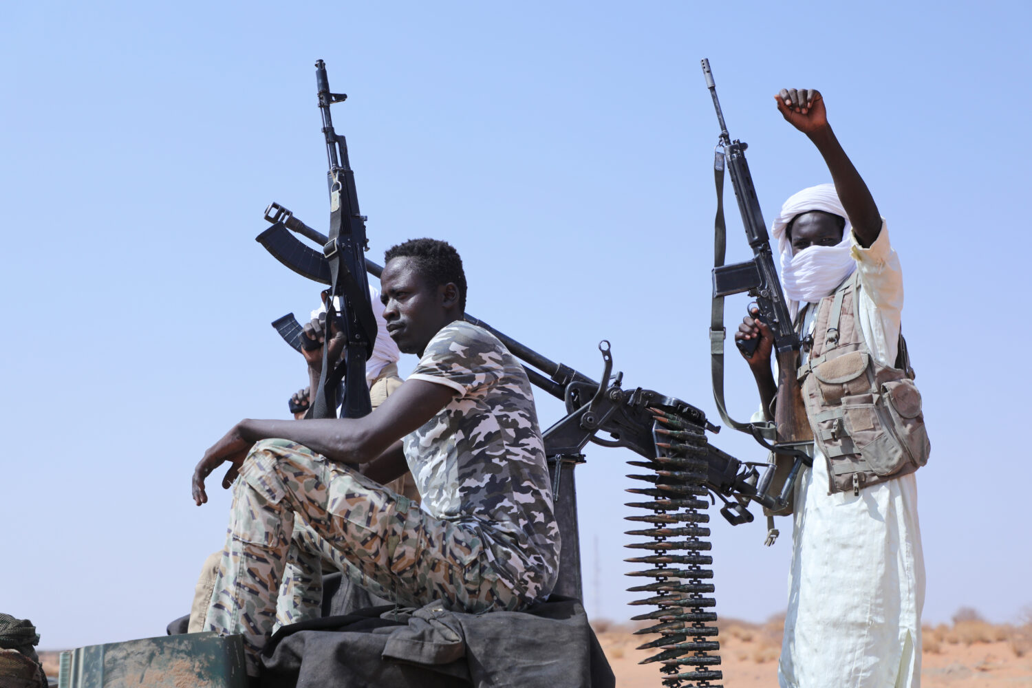 Fighters of armed defectors from the paramilitary Rapid Support Forces (RSF) celebrate, as they are...