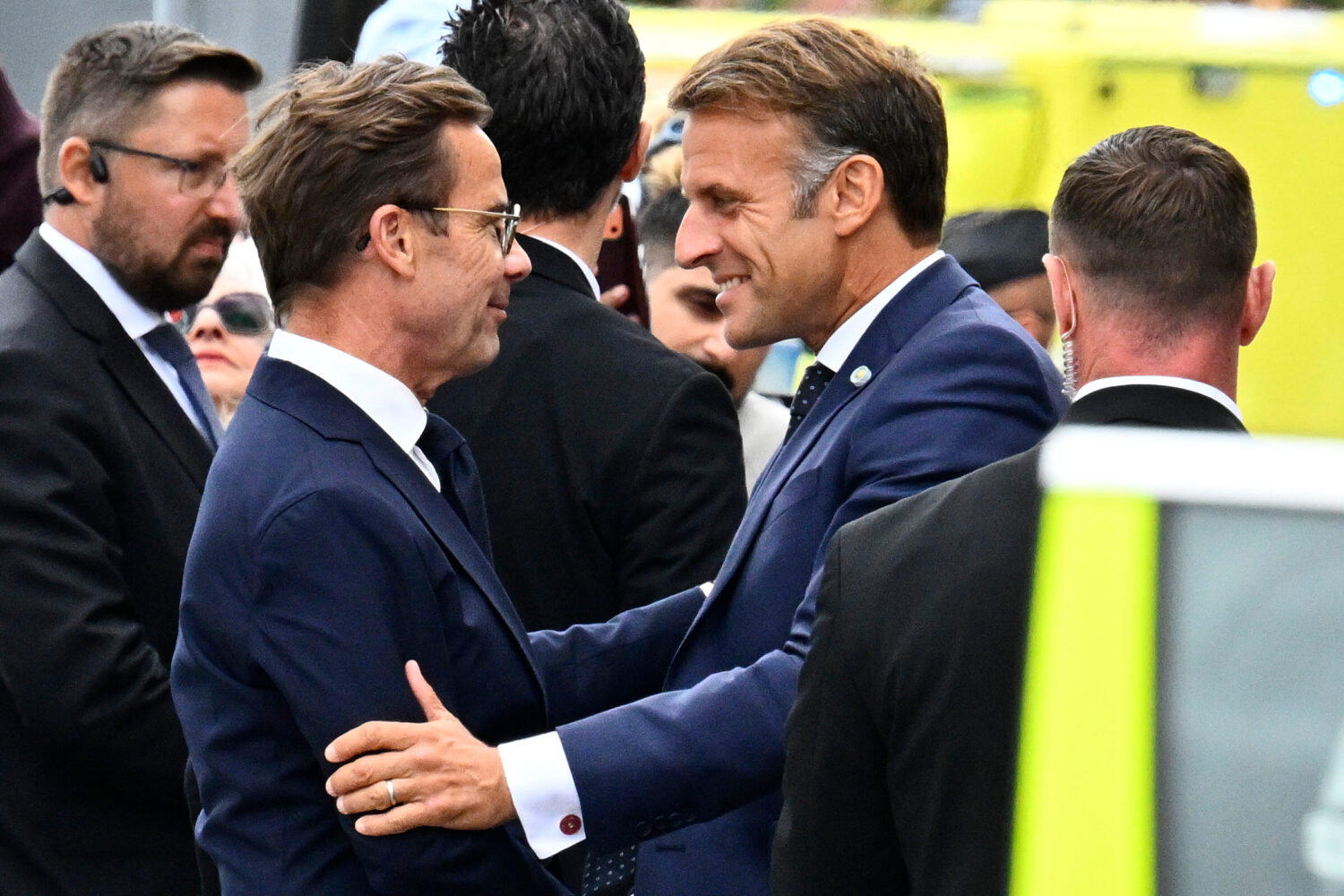 French President Emmanuel Macron, right, is welcomed by Swedish Prime Minister Ulf Kristersson, in ...
