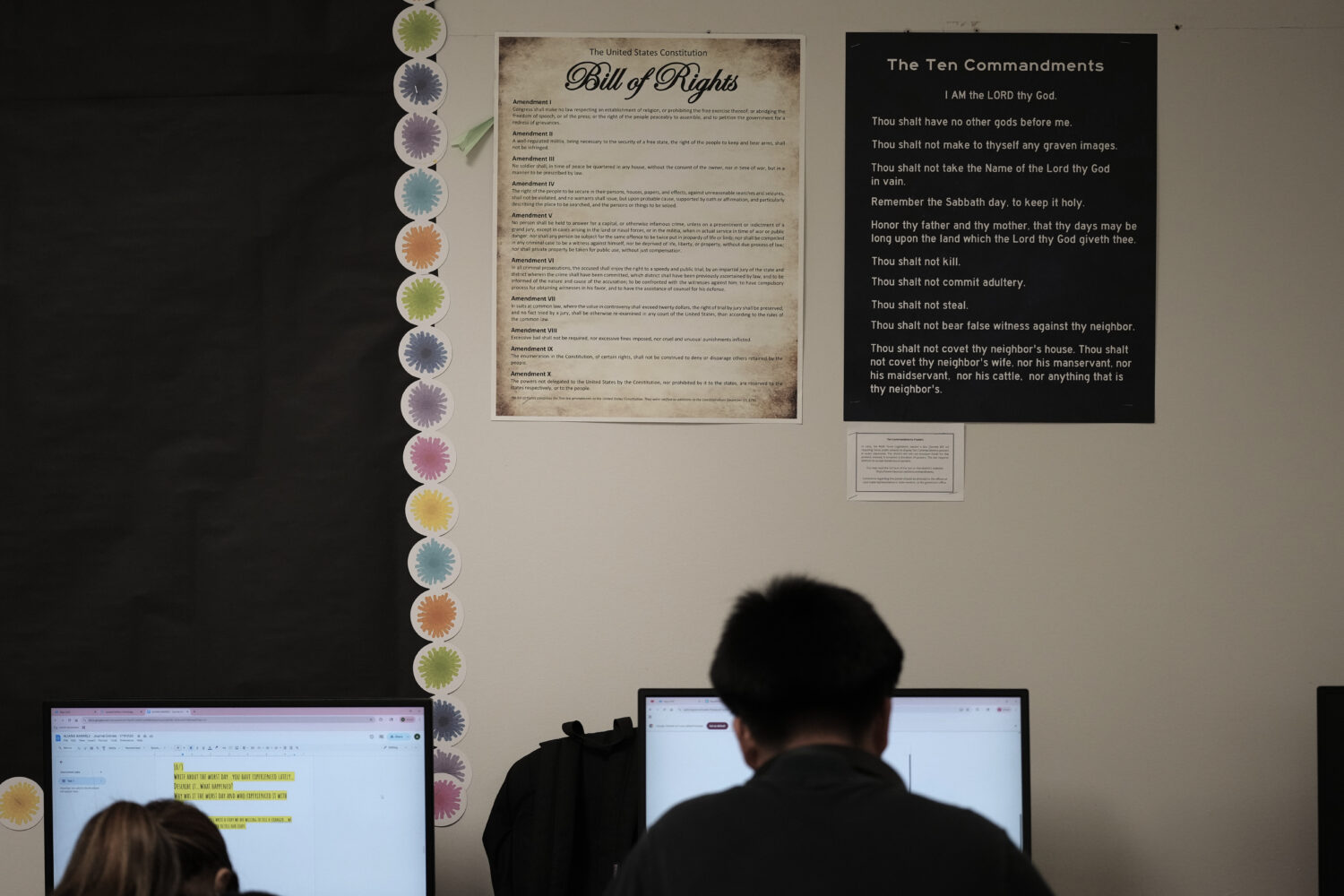 FILE - Students work under Ten Commandments and Bill of Rights posters on display in a classroom at...