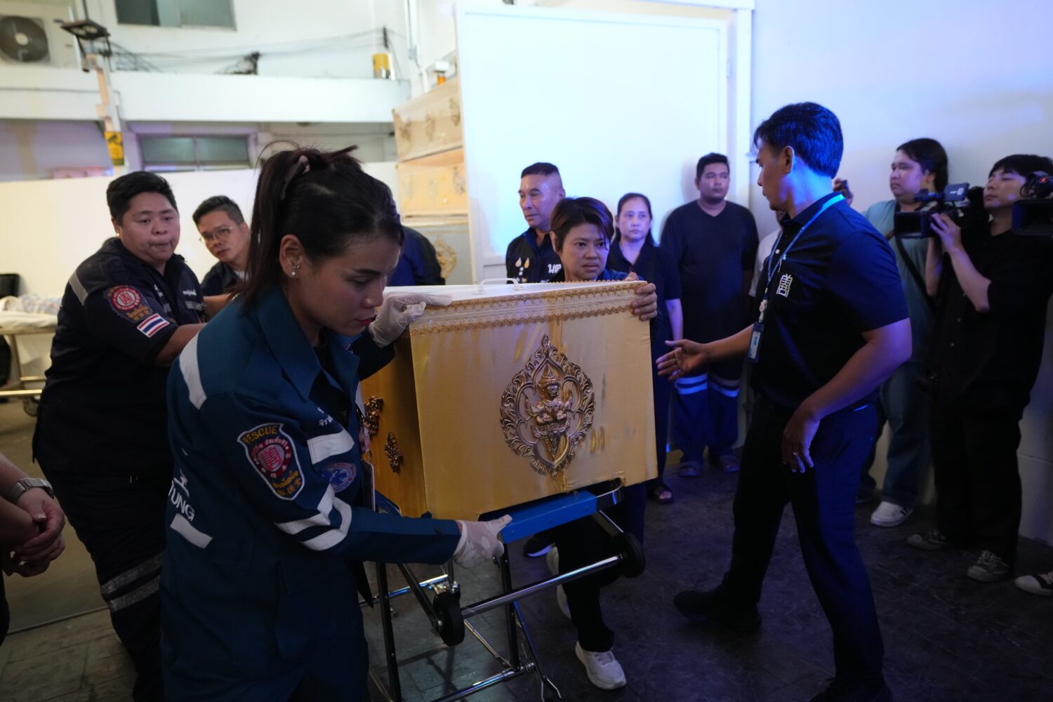 A coffin containing the body of a victim of Friday's shooting at the Debsirin Nonthaburi School, is...