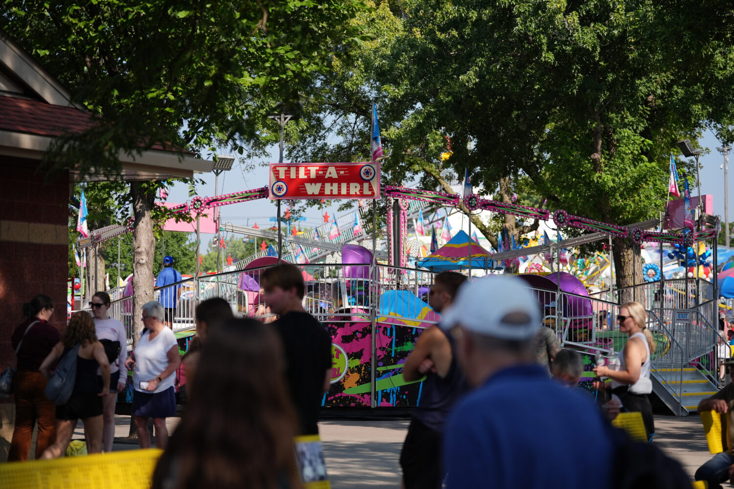 Fairgoers pass the Tilt-A-Whirl, Thursday, Aug. 27, 2026, at the Minnesota State Fair in Falcon Hei...