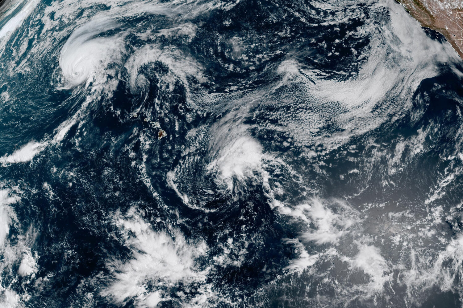This satellite image released by NOAA shows Hurricane Lala, upper left, over the Pacific Ocean, nor...