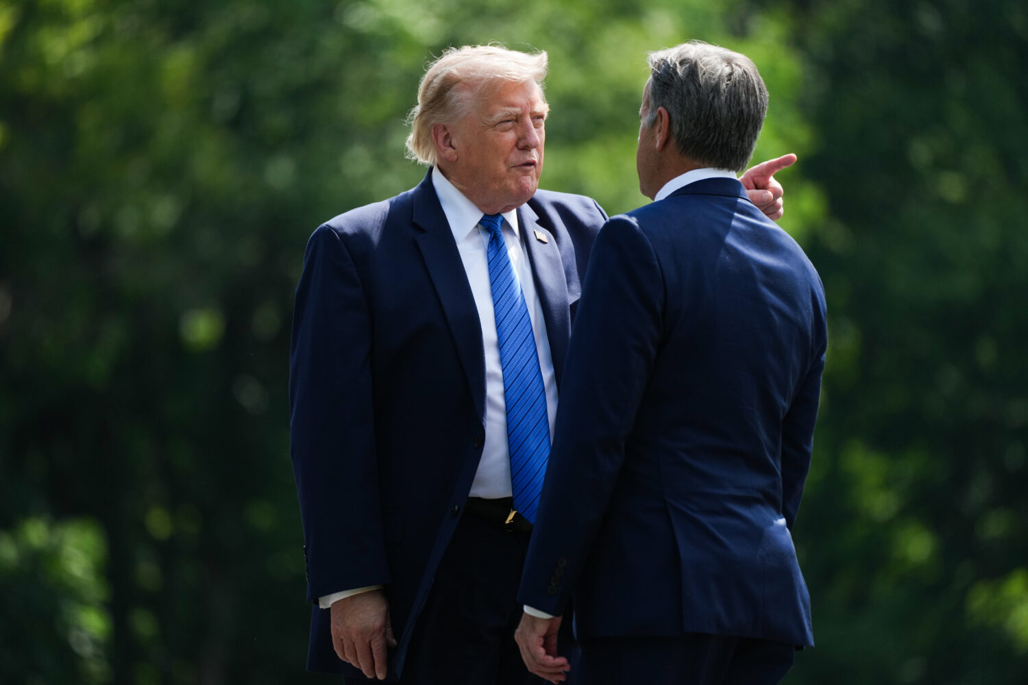 President Donald Trump, left, and CIA Director John Ratcliffe speak as they depart following a cabi...