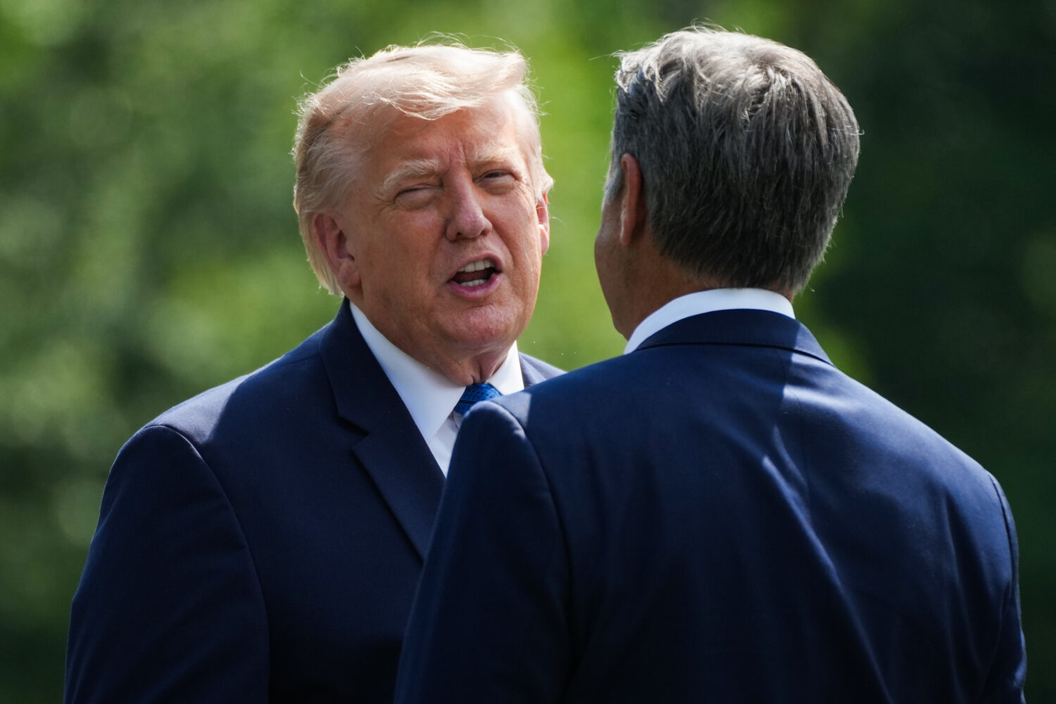 President Donald Trump, left, and CIA Director John Ratcliffe speak as they depart following a cabi...