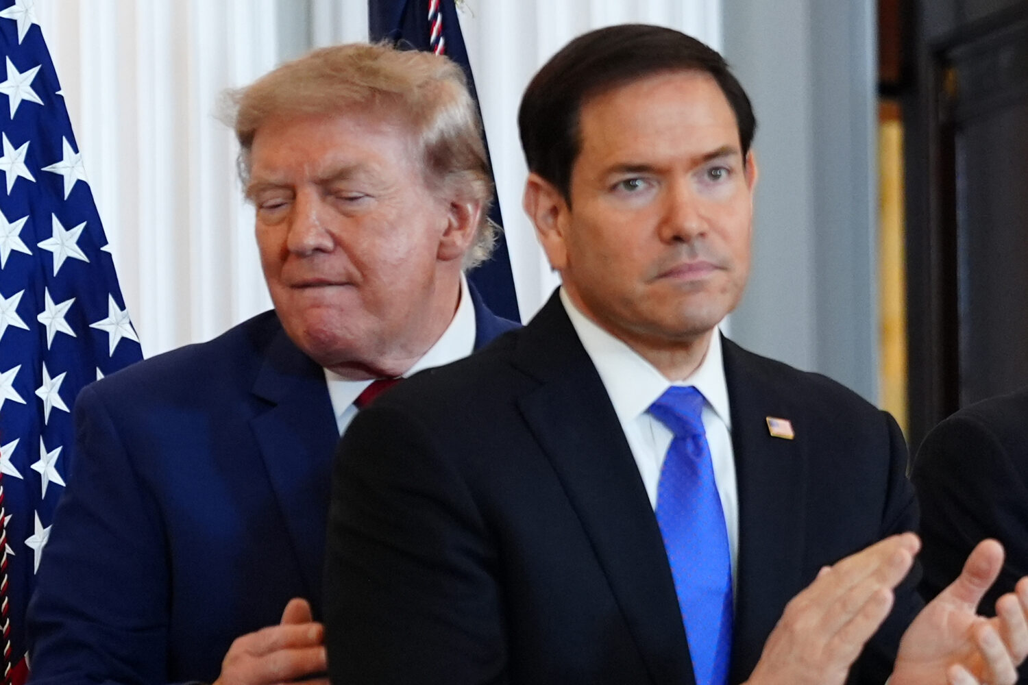 President Donald Trump walks past Secretary of State Marco Rubio as he arrives for a roundtable on ...