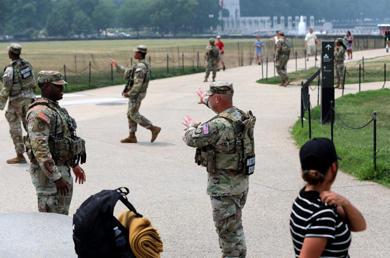 Members of the National Guard patrol around the Washington Monument, before Marine One, with Presid...