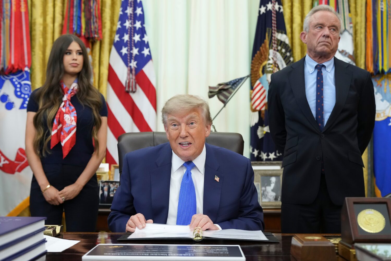 President Donald Trump speaks as Health and Human Services Secretary Robert F. Kennedy Jr., right, ...