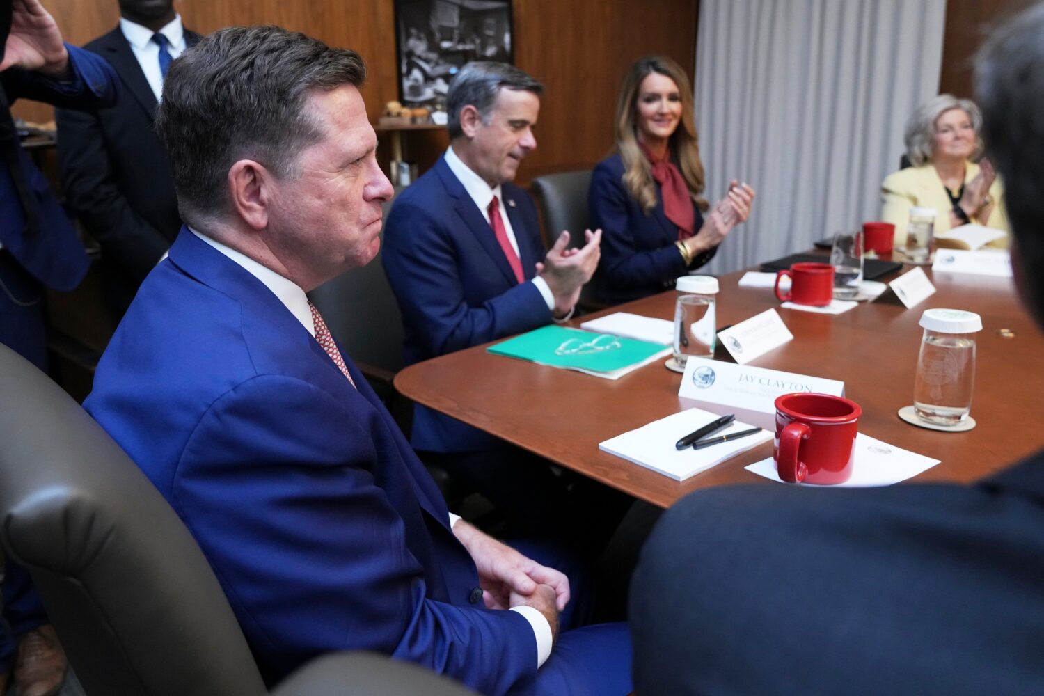 Jay Clayton, left, listens during a cabinet meeting, Friday, July 31, 2026, at Camp David, the pres...