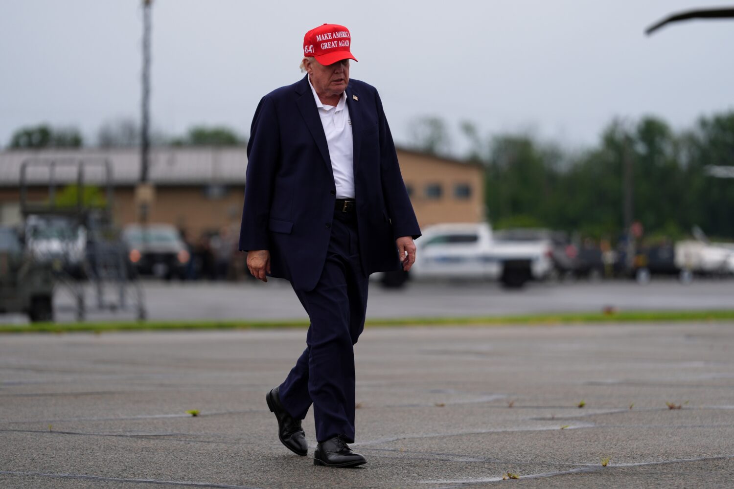 President Donald Trump walks to board Air Force One at Morristown Airport, Sunday, Aug. 16, 2026, i...