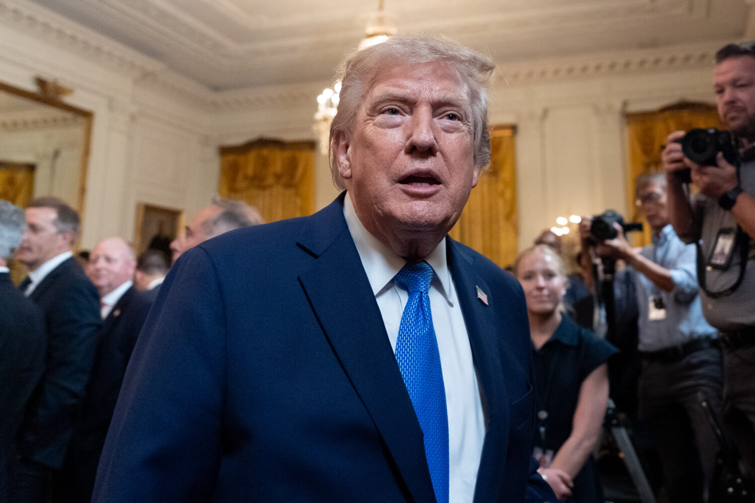 President Donald Trump speaks with a reporter as he departs after an event for Olympic athletes, co...