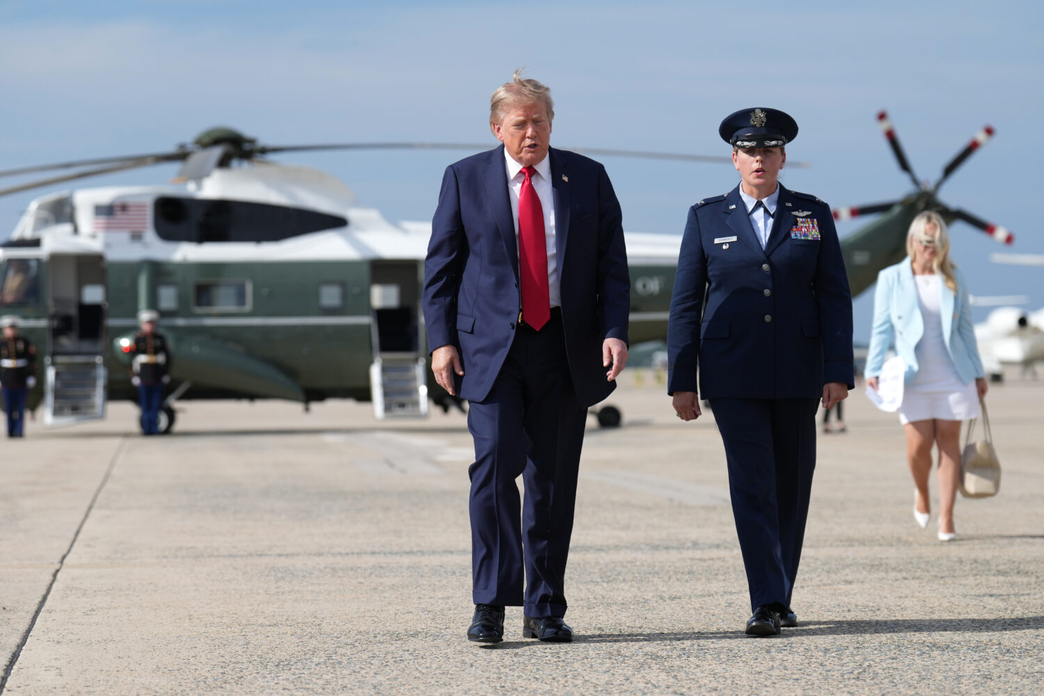 President Donald Trump, left, walks from Marine One to board Air Force One, Friday, Aug. 21, 2026, ...