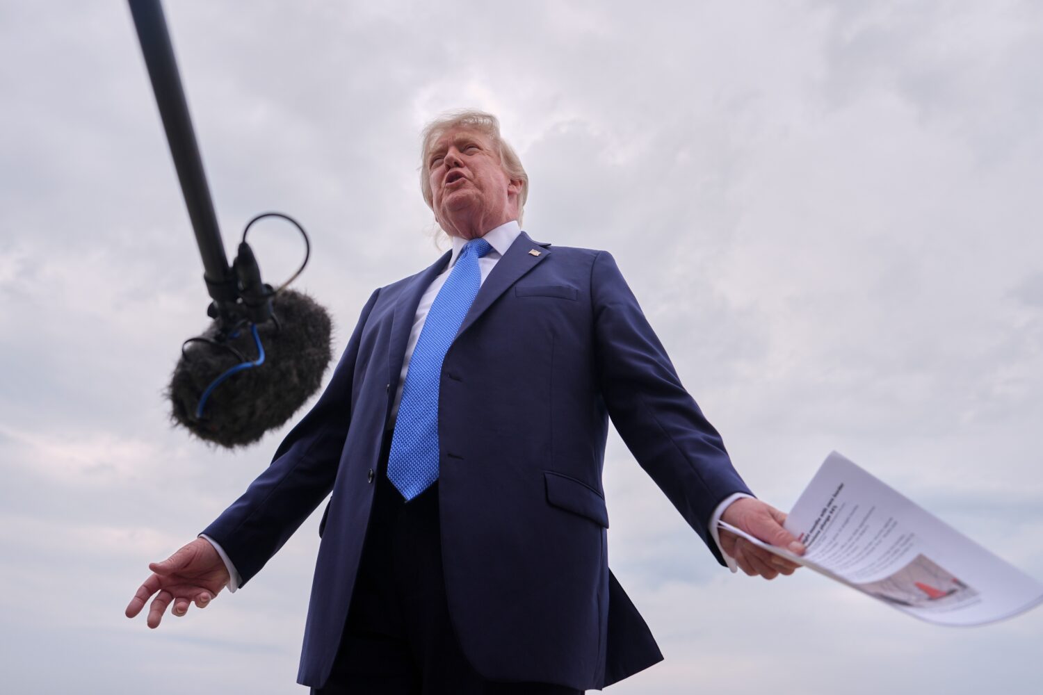 President Donald Trump speaks with reporters before boarding Air Force One, Friday, Aug. 14, 2026, ...