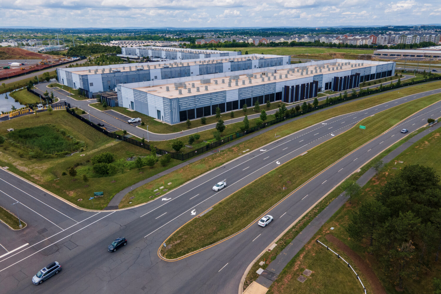 FILE - Cars drive past data centers, July 16, 2023, in Ashburn, Va. (AP Photo/Ted Shaffrey, File)Cr...