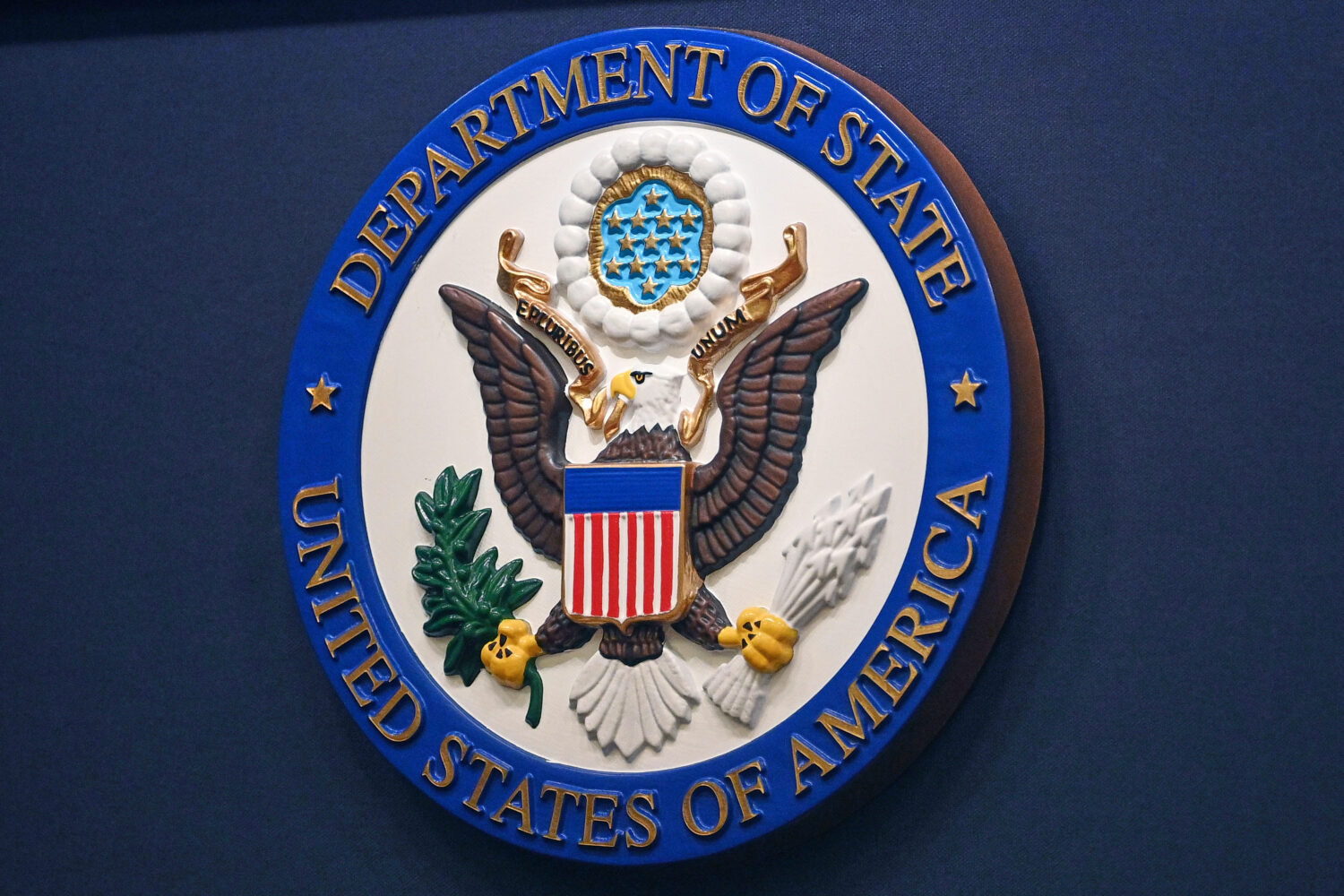 FILE - The State Department seal is seen on the briefing room lectern at the State Department in Wa...