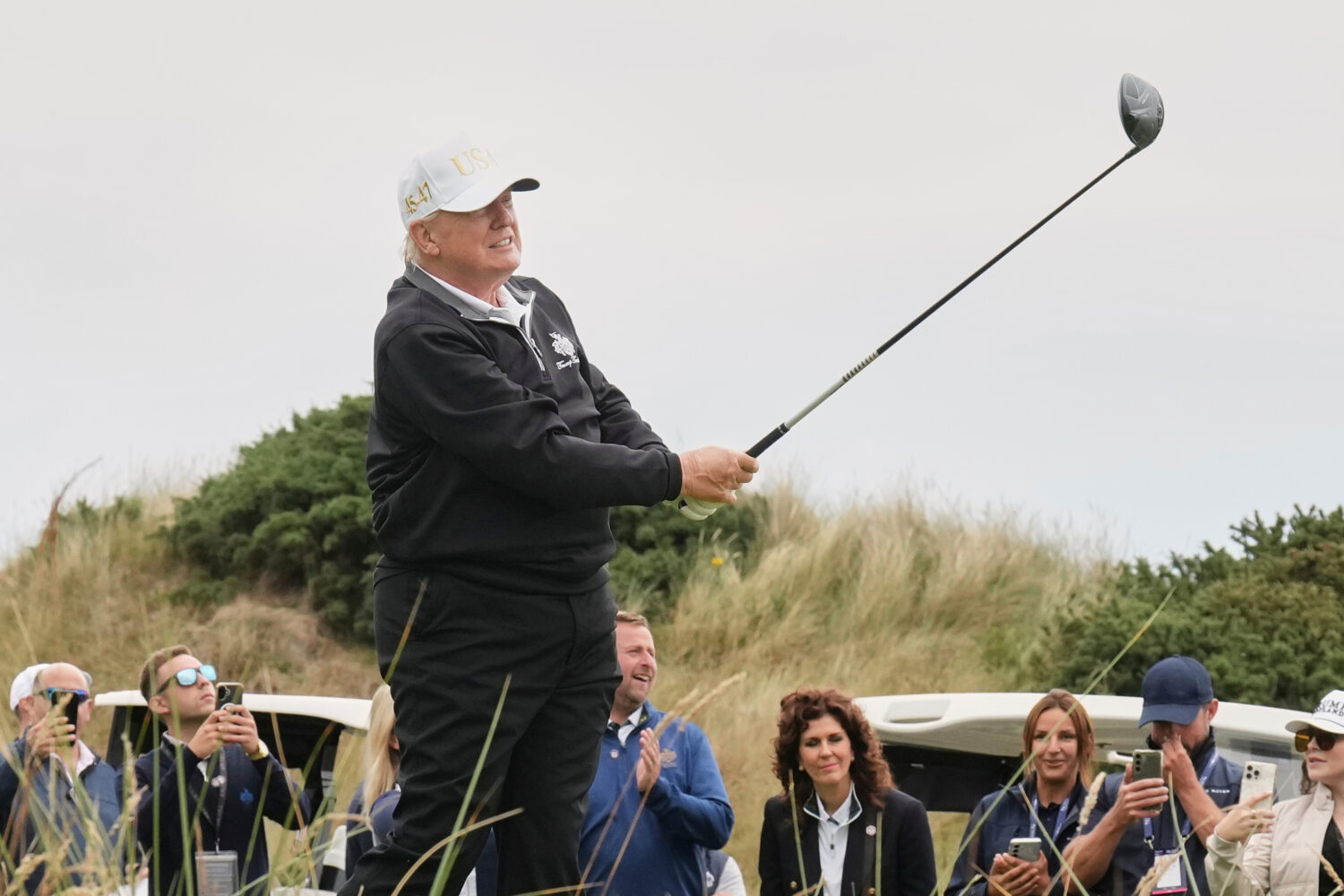 FILE - President Donald Trump tees off during the opening ceremony for the Trump International Golf...