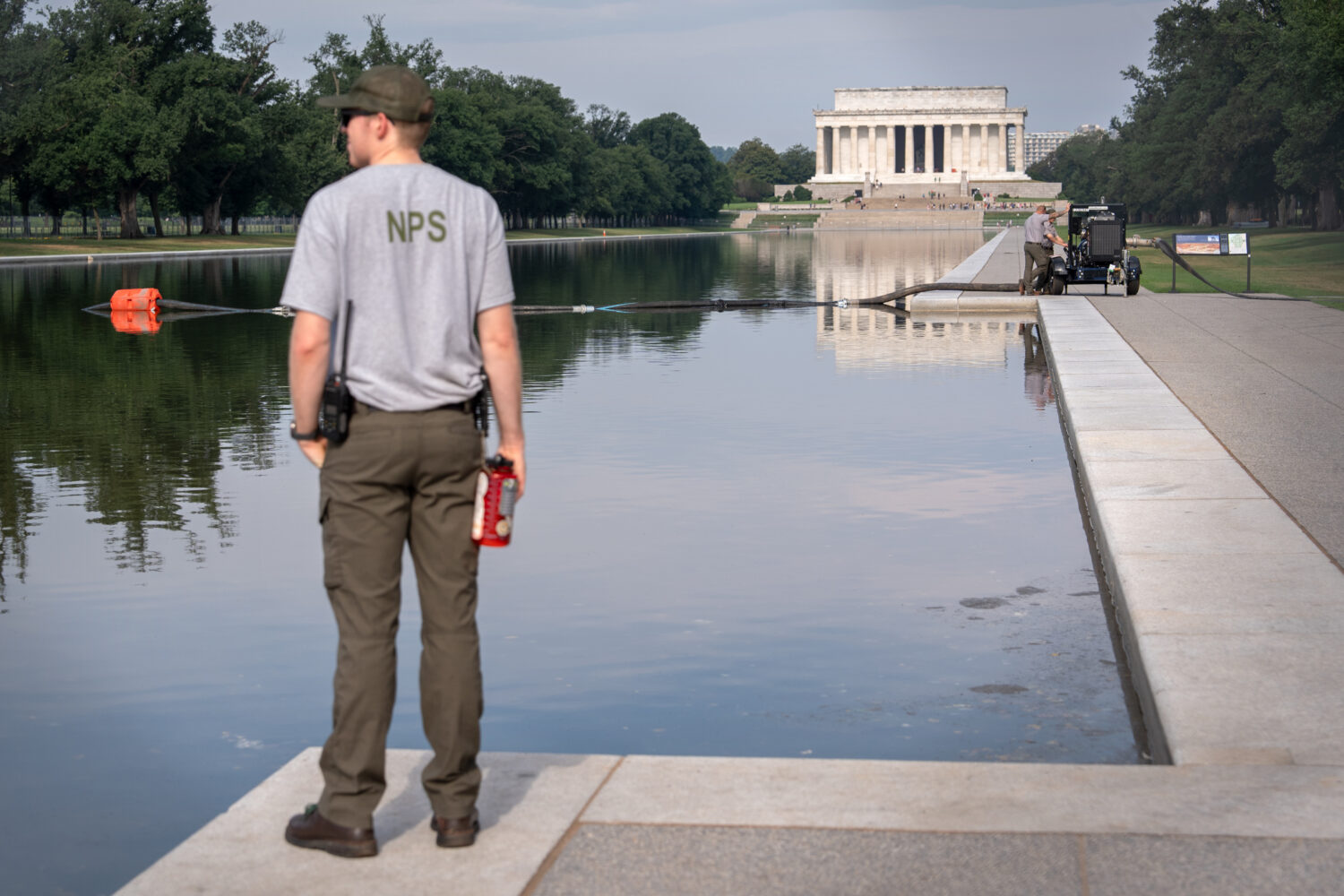 FILE - A National Park Service worker stands near a pump placed next to the Lincoln Memorial Reflec...