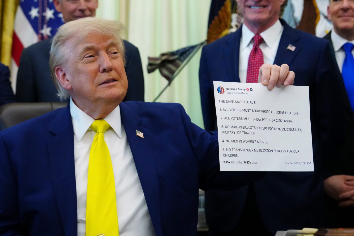 FILE - President Donald Trump holds up an image taken from his Truth Social account at an event abo...