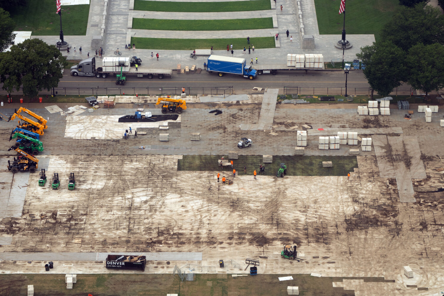 FILE - Workers dismantle structures from Salute to America, an Independence Day event honoring the ...