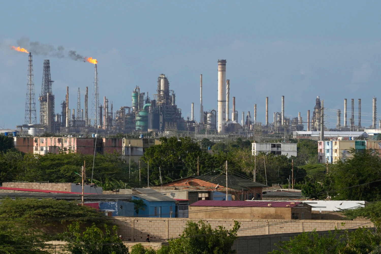 FILE - Flames rise from flare stacks at the Amuay refinery in Los Taques, Venezuela, Jan. 14, 2026....