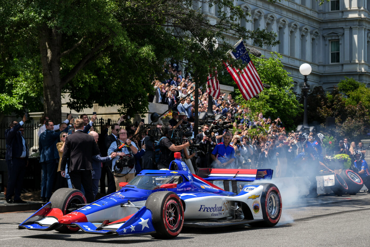 IndyCar Series driver David Malukas drives a race car down West Executive Drive during an event wit...
