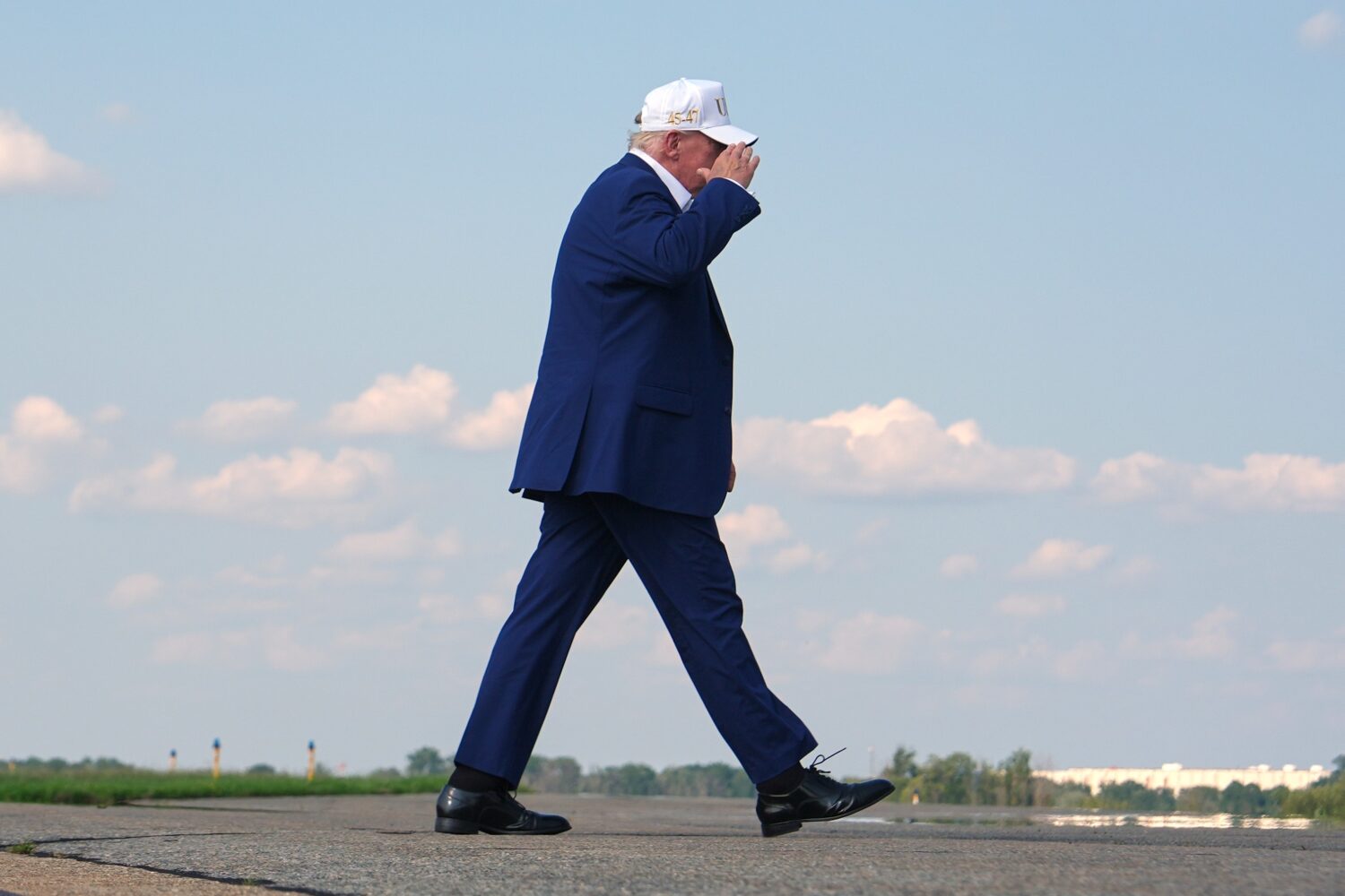 President Donald Trump walks to board Air Force One at Morristown Airport, Sunday, Aug. 9, 2026, in...