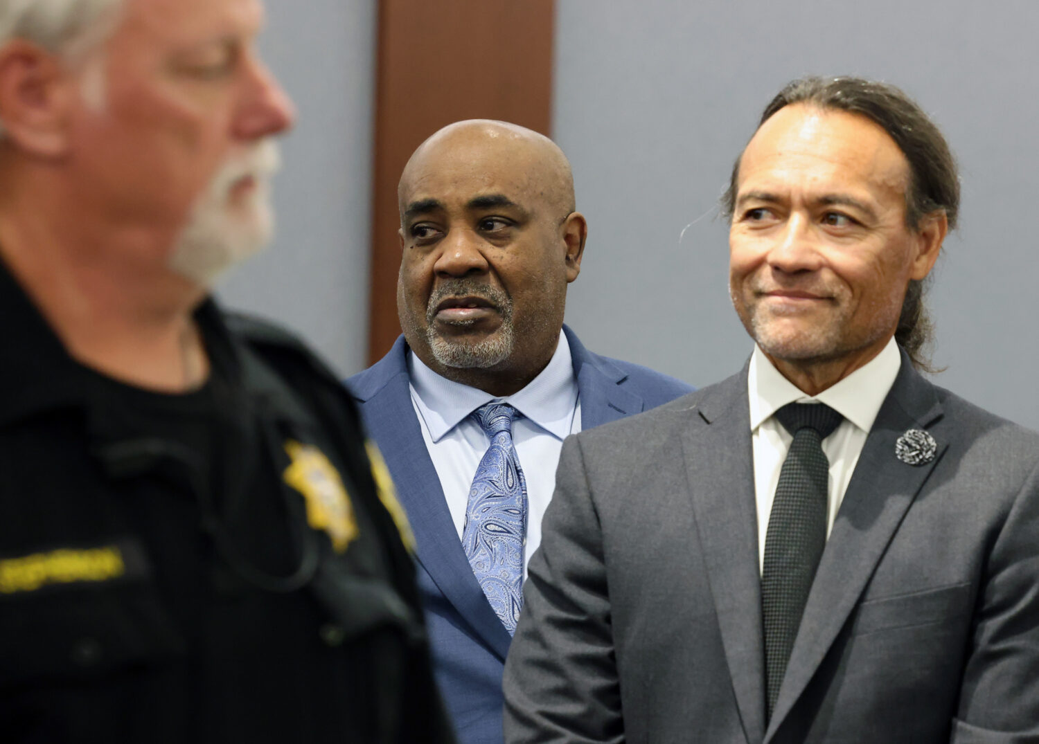 Duane Davis, center, stands with his attorney Michael Sanft, right, as prospective jurors enter the...