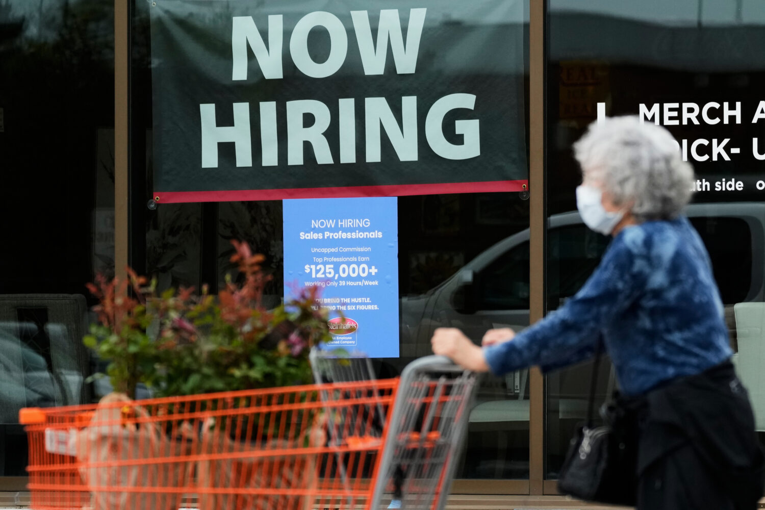 FILE - Hiring sign for sales professionals is displayed at a store, in Vernon Hills, Ill., Wednesda...