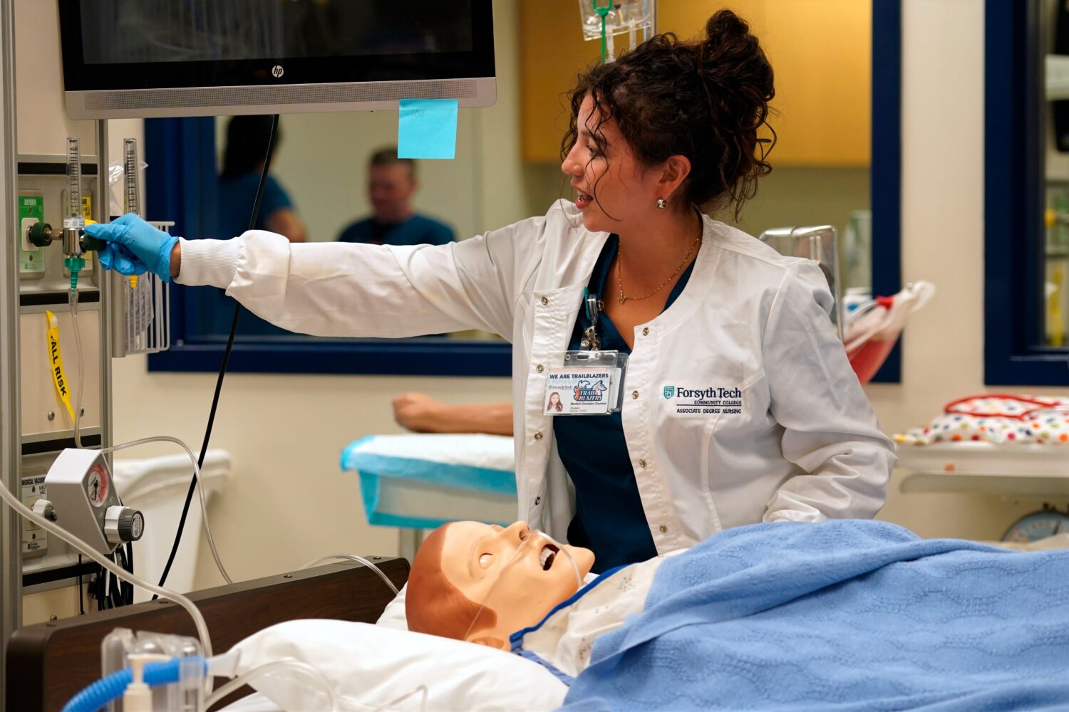 Nursing student Maribel Gonzalez Guzman checks a patient manikin in the simulation lab at Forsyth T...