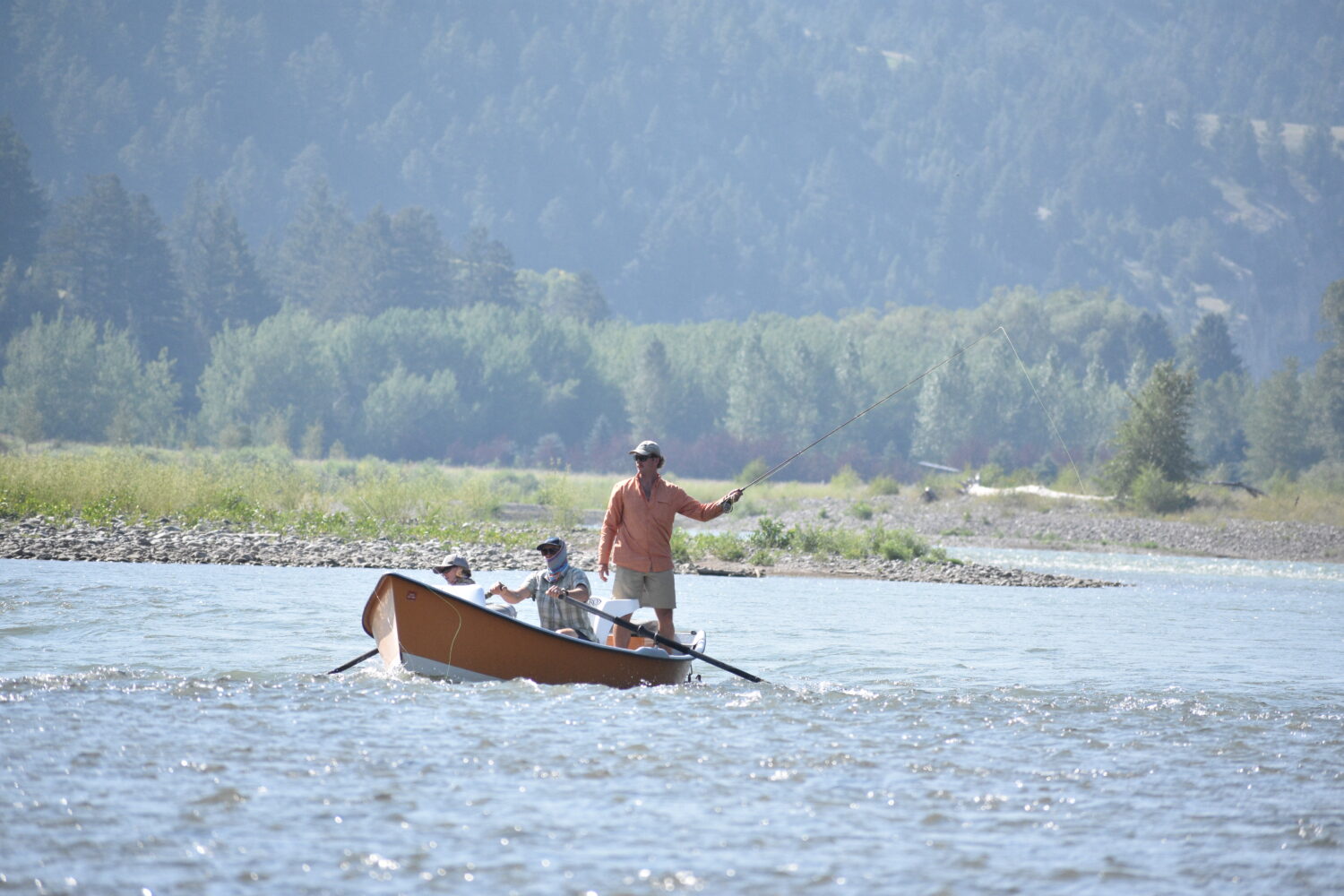 A drift boat with people fly fishing floats down the Yellowstone River, Friday, July 31, 2026, near...
