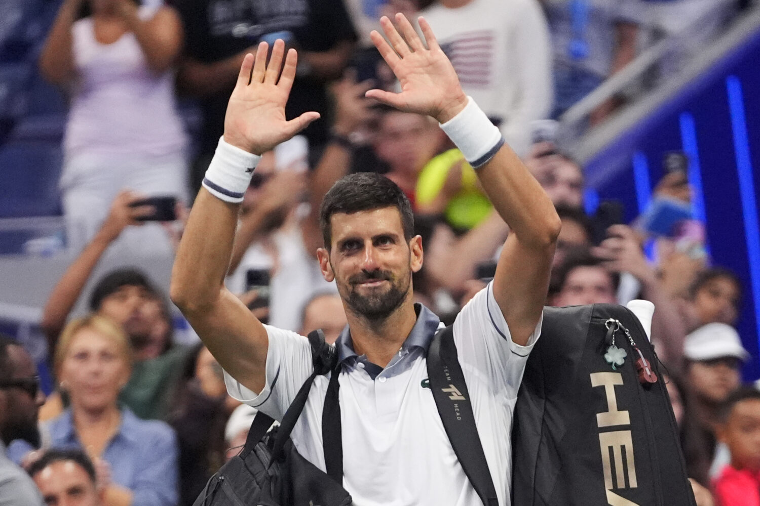 Novak Djokovic, of Serbia, gestures to the crowd after he lost to Mariano Navone, of Argentina, dur...