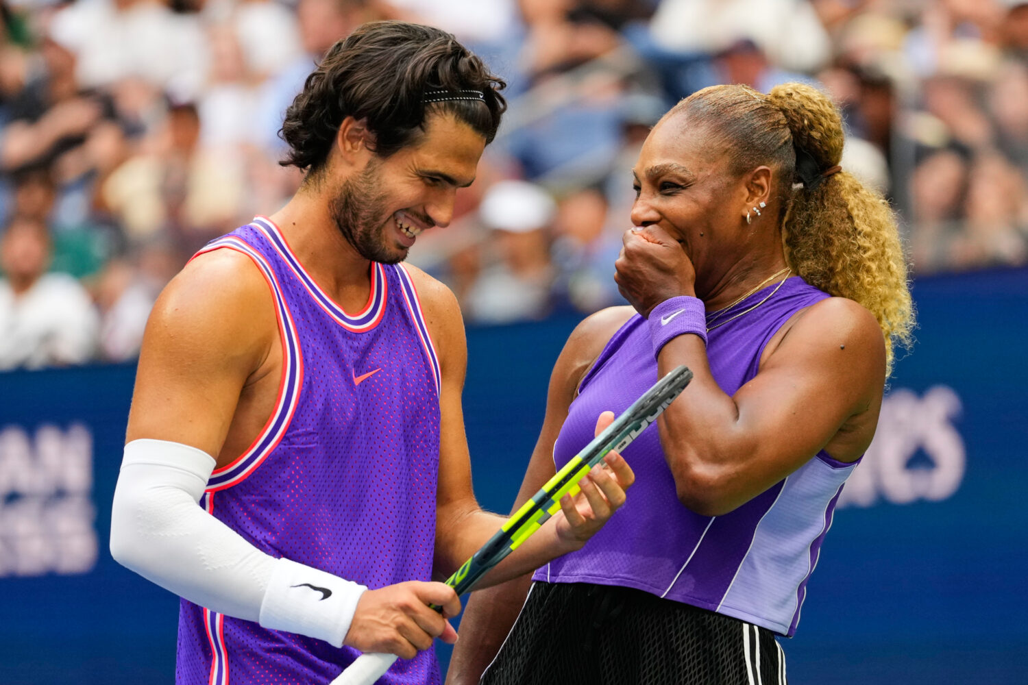 Carlos Alcaraz, of Spain, left, and Serena Williams, of the United States, talk on the court during...