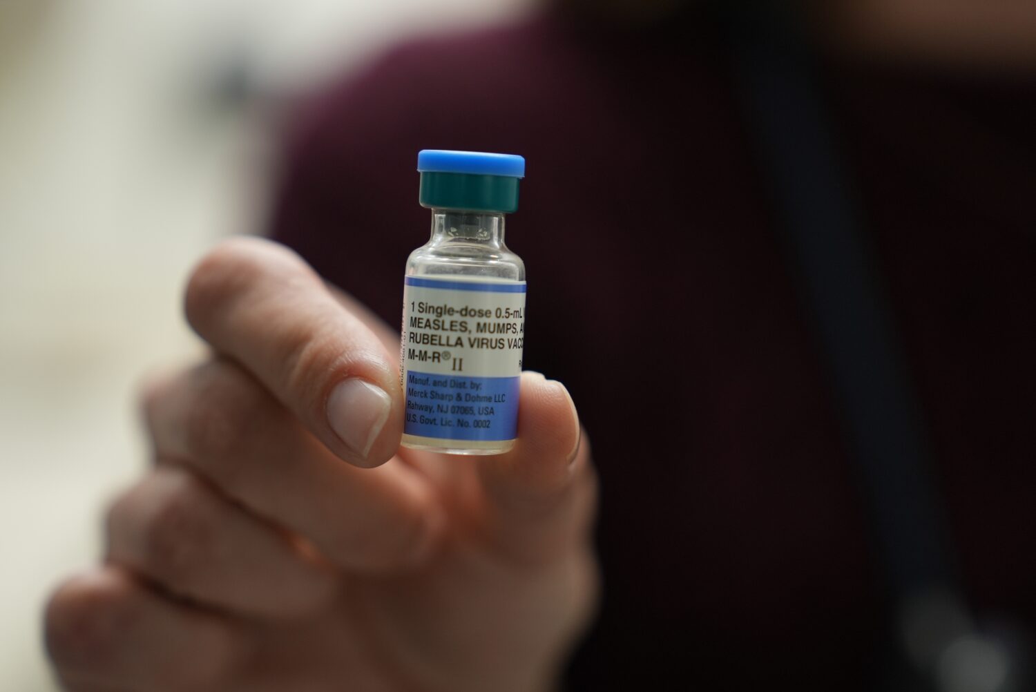 FILE - Dr. Jessica Early holds a vial of the combination measles, mumps and rubella vaccine at Pris...