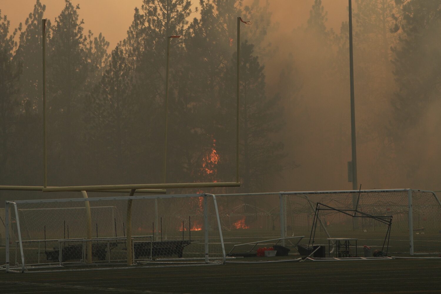 Old Trails Fire burns near Dwight Merkel Sports Complex, Saturday, Aug. 1, 2026, in Spokane, Wash. ...