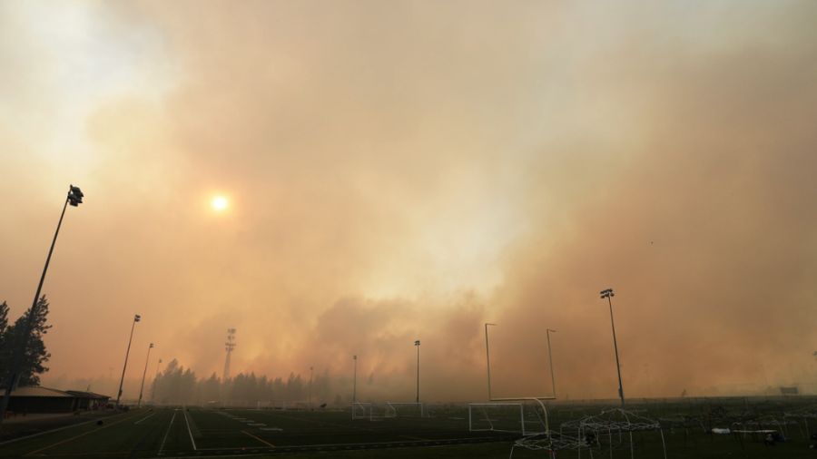 Heavy smoke from the Old Trail Fire above the Dwight Merkel Sports Complex. (AP Photo/Young Kwak)