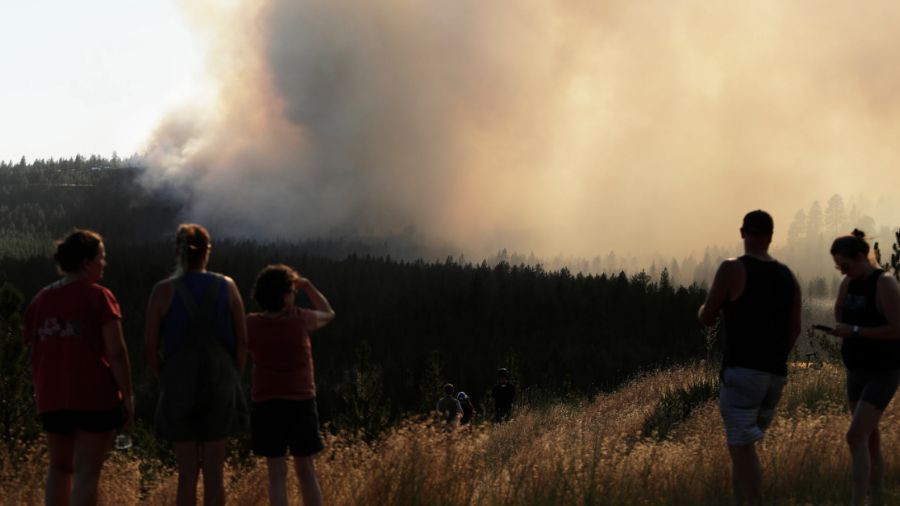 Local residents watch the Old Trail Fire from W. Northwest Blvd. in Spokane. (AP Photo/Young Kwak)