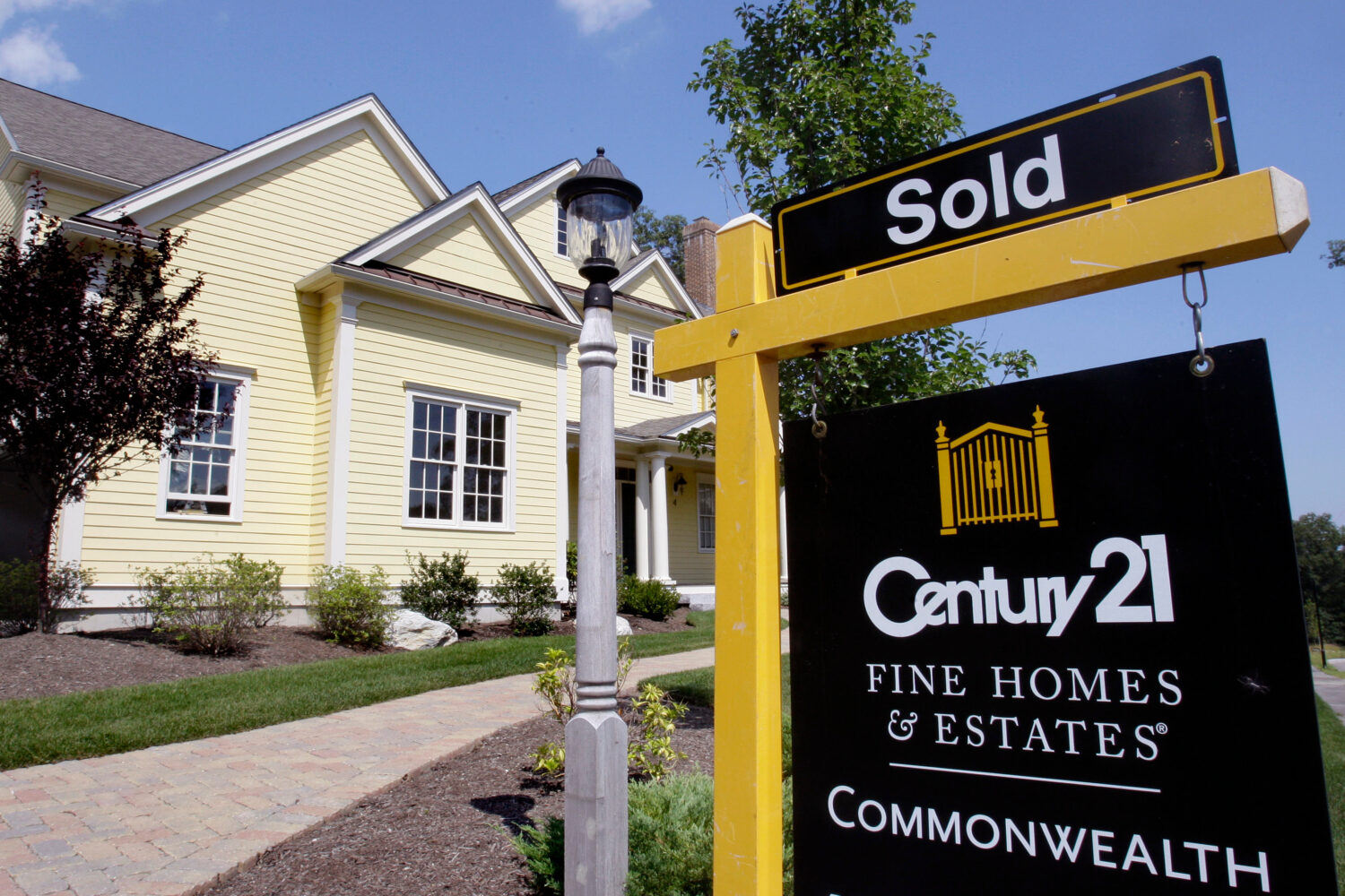 FILE - A sold sign is posted outside a newly constructed luxury home in Wellesley, Mass., Aug. 25, ...