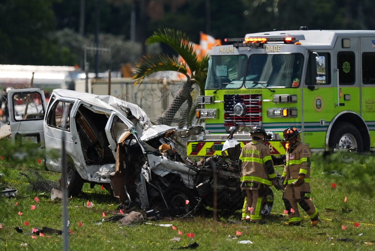 Miami Dade Fire Rescue officials inspect a damaged vehicle two days after an Amazon cargo plane ove...