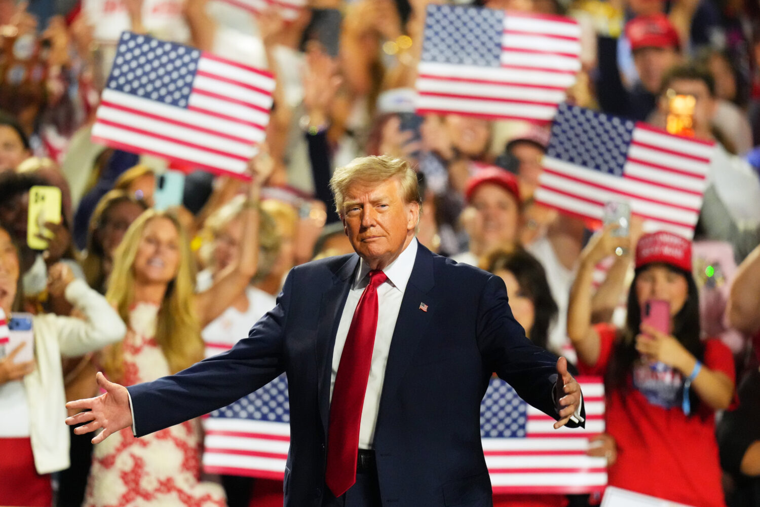 President Donald Trump greets supporters as he arrives on the stage at the Republican convention Th...