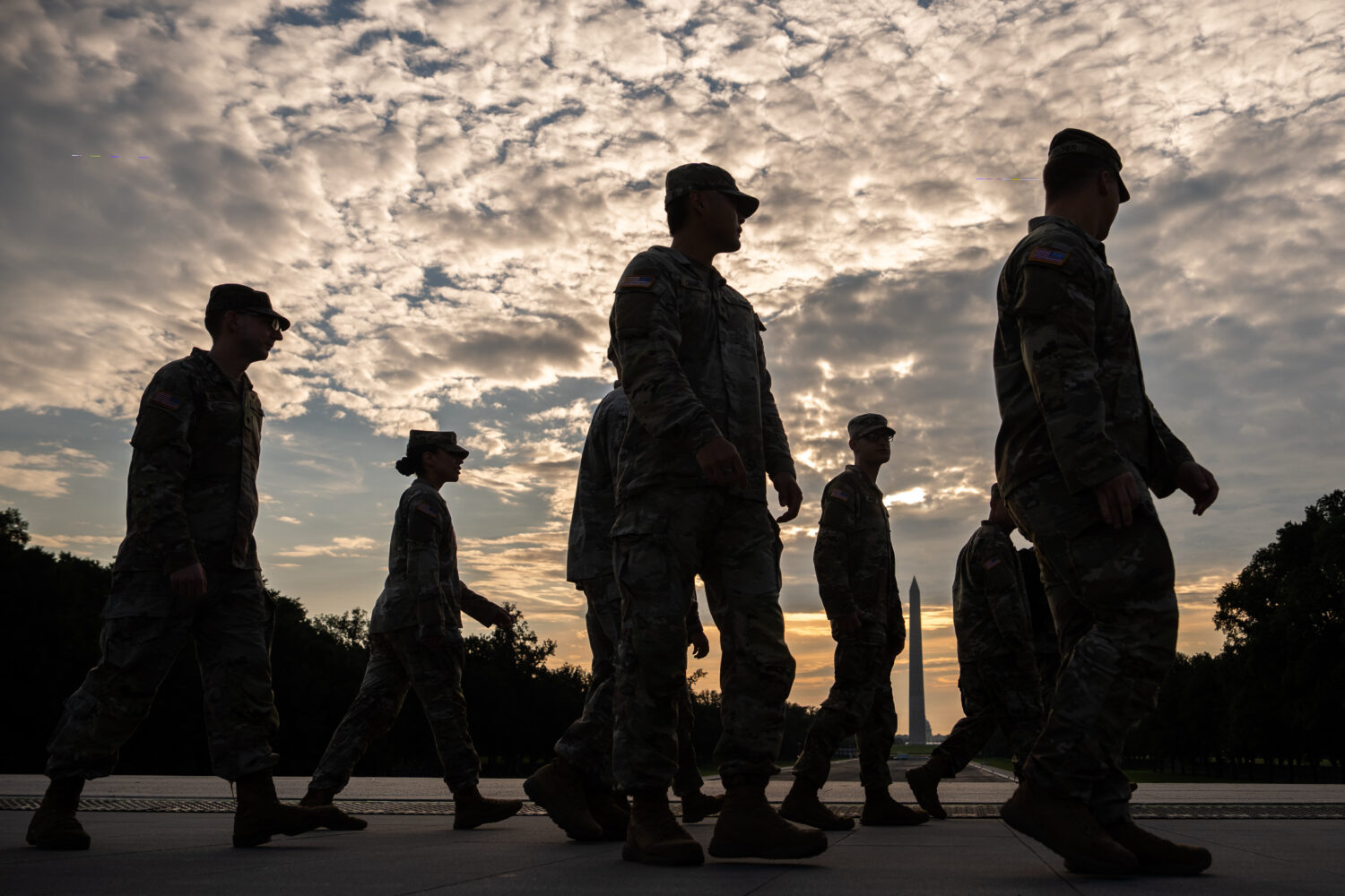 Members of the National Guard walk past the Lincoln Memorial Reflecting Pool before the March on Wa...