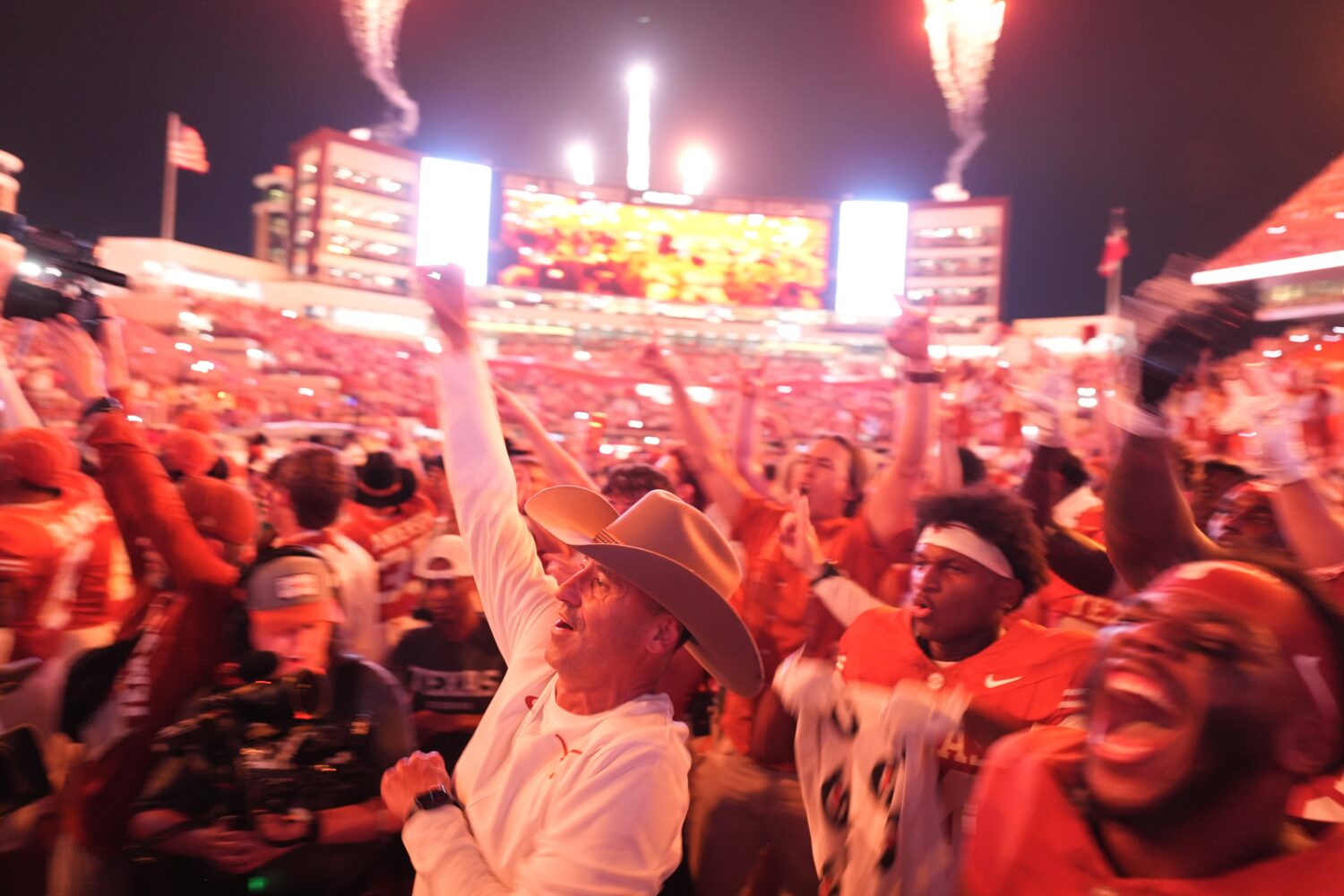 Texas head coach Steve Sarkisian, center and Texas players celebrate their win over Ohio State in a...