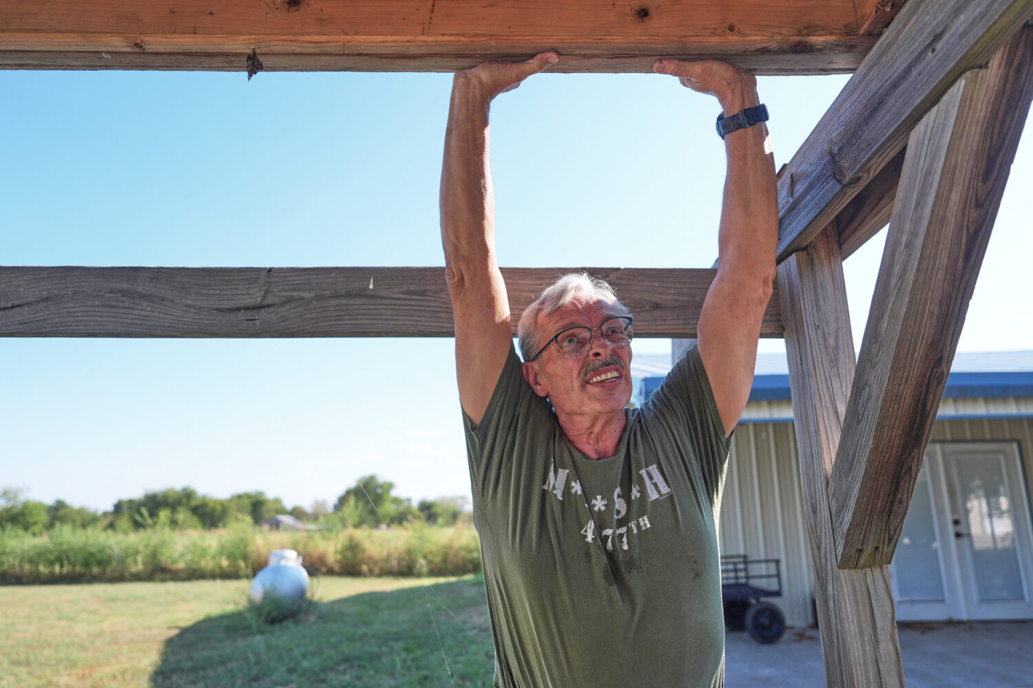 Ed Westrick, 59, adjusts a roof on a small building at his rural home near Commerce, Texas, Friday,...