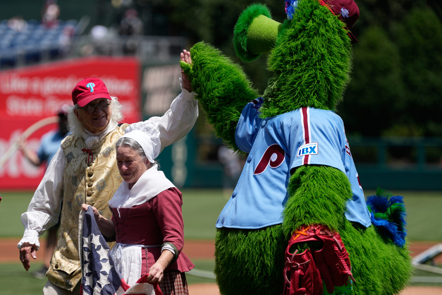 Bill Robling as Benjamin Franklin, left, and Carol Spacht as Betsy Ross, center, greet the Philadel...