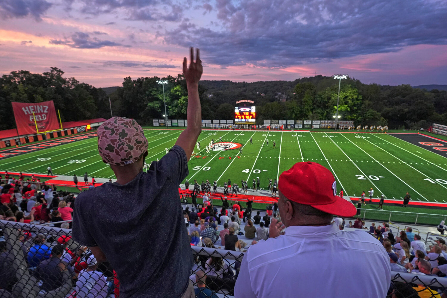 Aliquippa High School football fans cheer during a high school football game between Aliquippa and ...