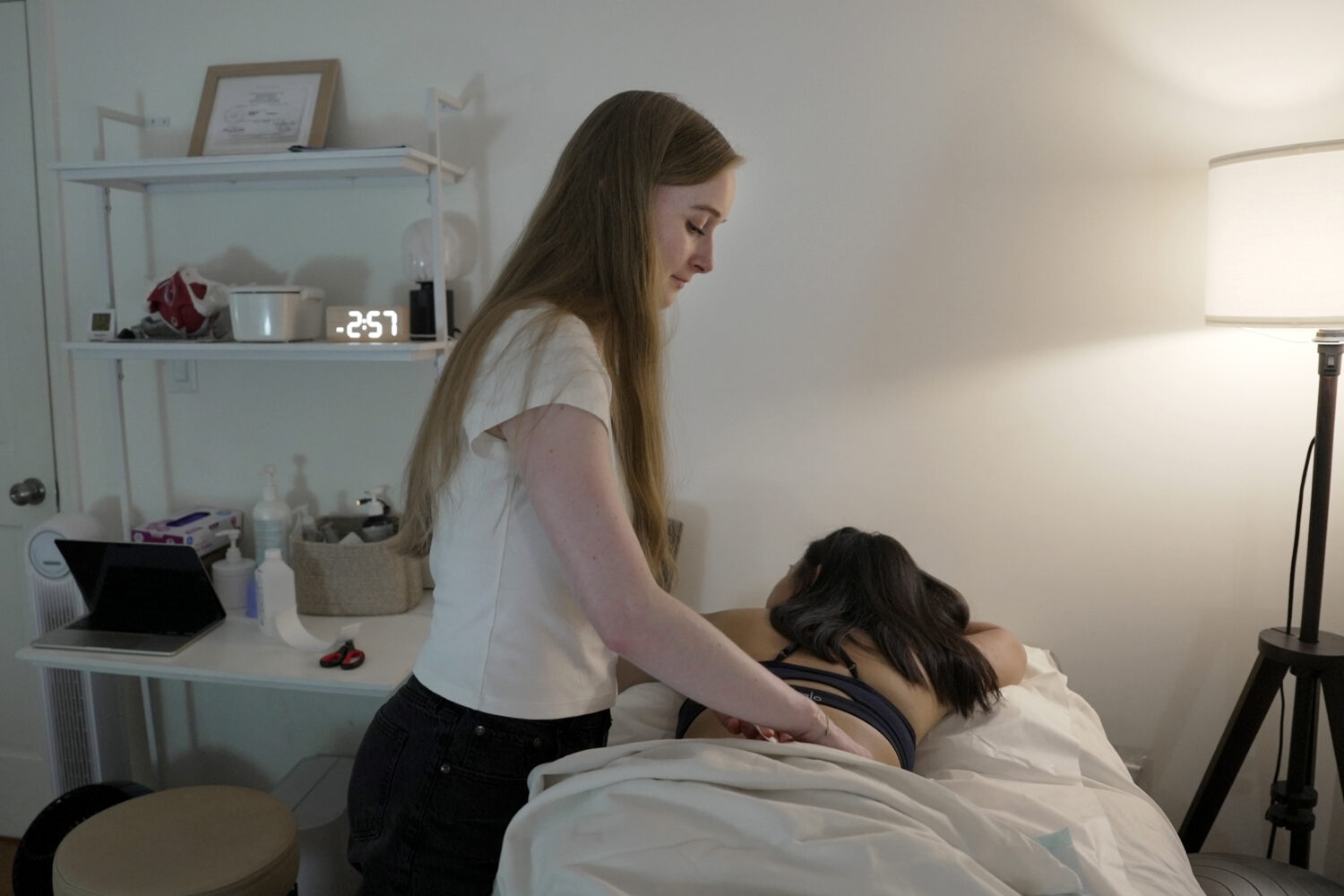 Zoë Armstrong, an endometriosis patient, rests during her pelvic floor physical therapy appointmen...