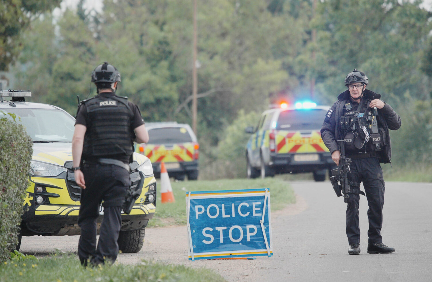Police stand at a road block on the road to RAF Fairford after an incident, in Whelford, England, S...