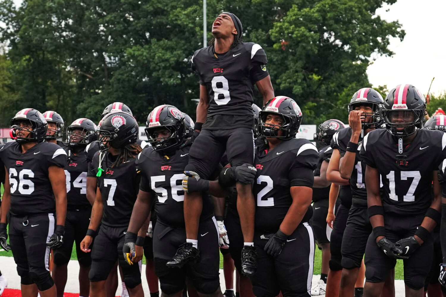 CORRECTS FIRST NAME TO AKIVA FROM AKIRA - Aliquippa Senior running back Akiva Woods (8) leads a pre...
