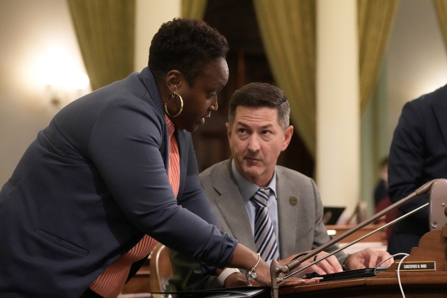 Assemblymember LaShae Sharp-Collins, left, talks with Assemblymember Christopher Ward during an Ass...