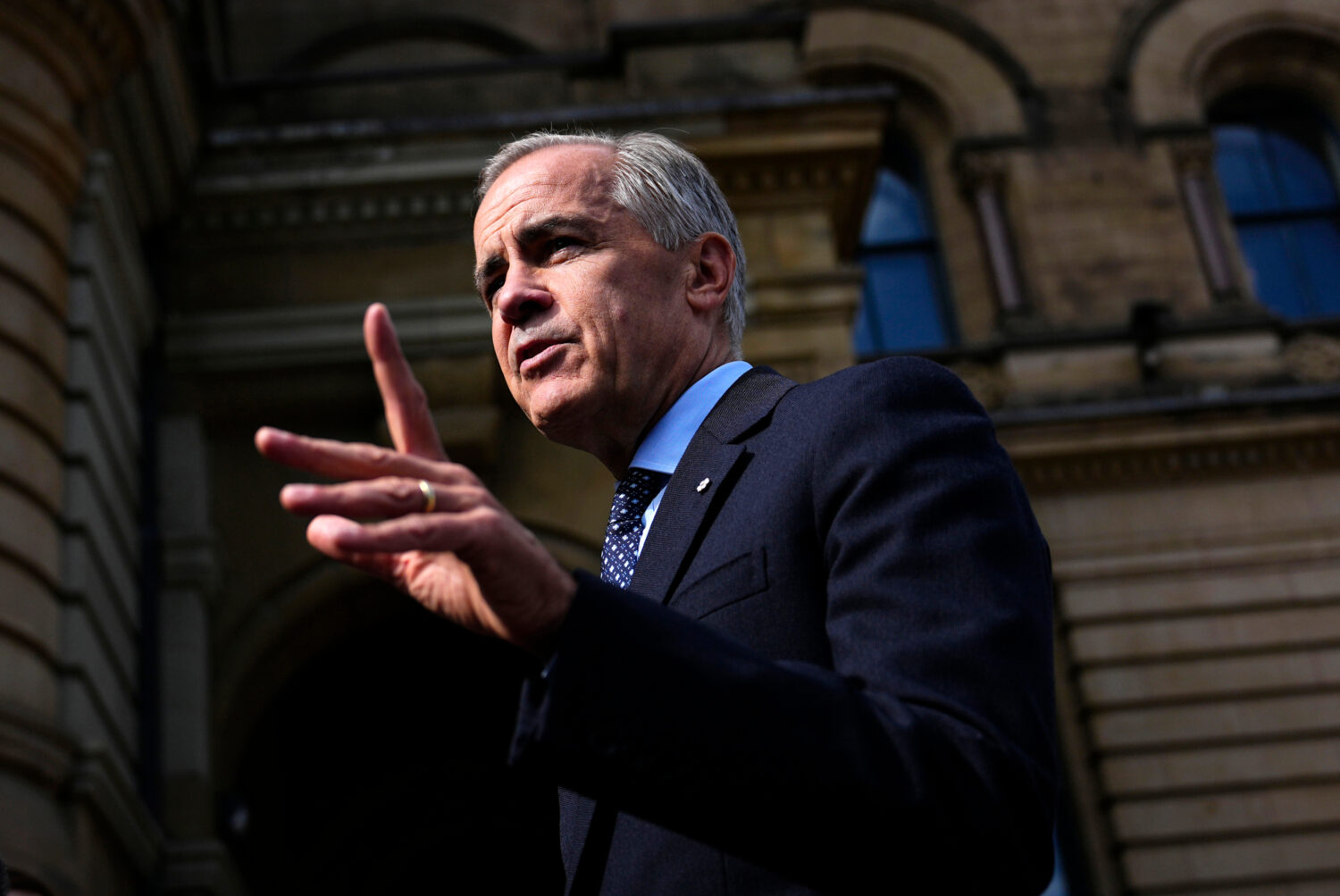 Canadian Prime Minister Mark Carney speaks with members of the media as he arrives at the Office of...