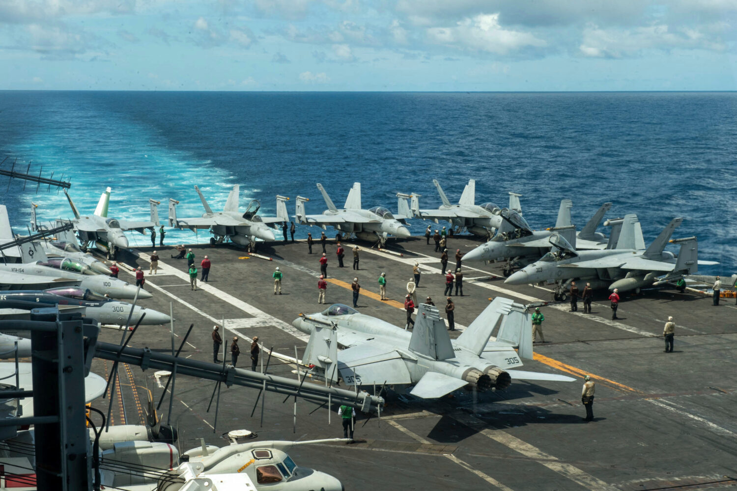 FILE - In this photograph released by the U.S. Navy, military planes stand on the flight deck of th...