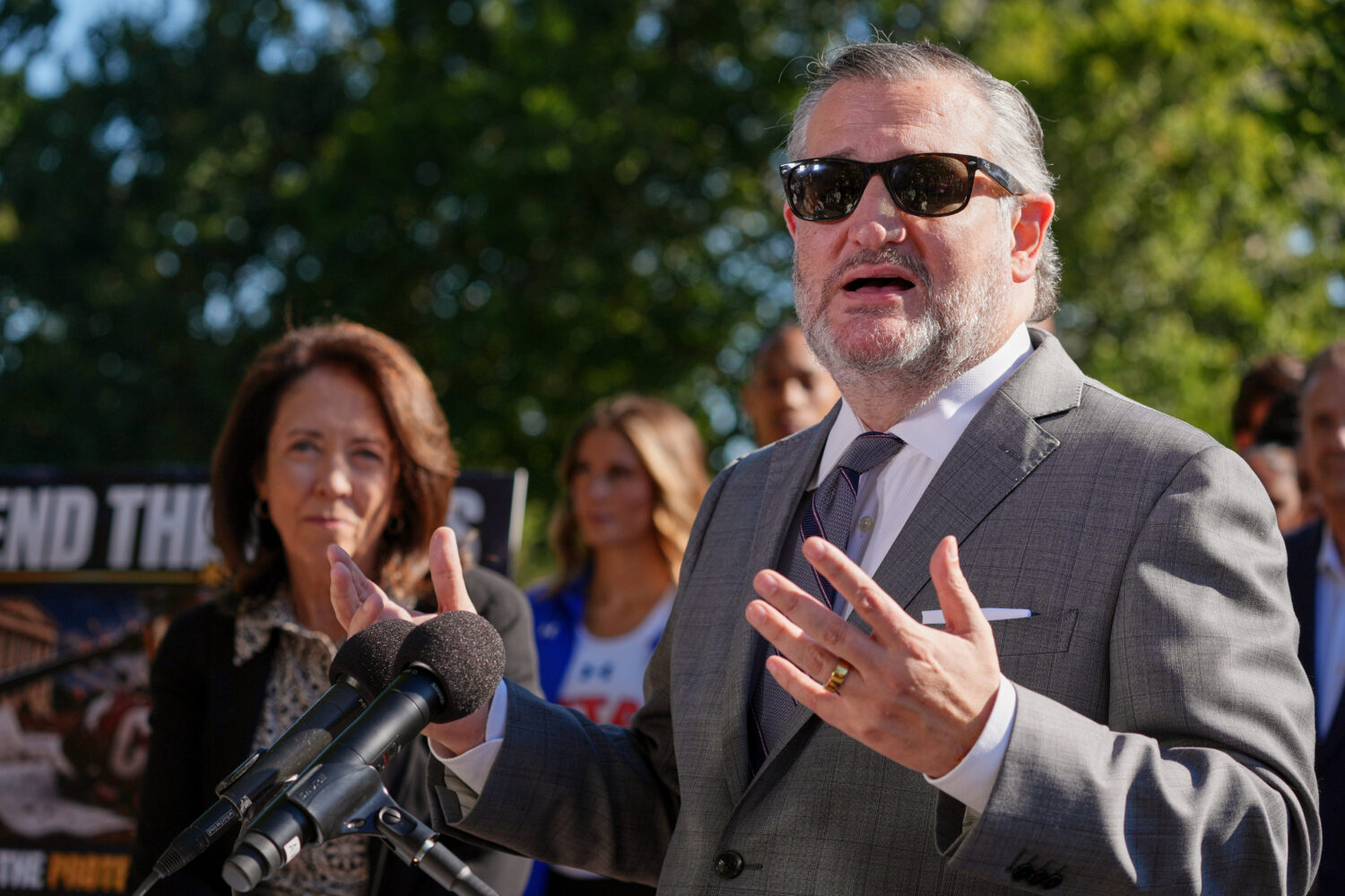 Sen. Ted Cruz, R-Texas, right, speaks as Sen. Maria Cantwell, D-Wash., left, listens during a news ...